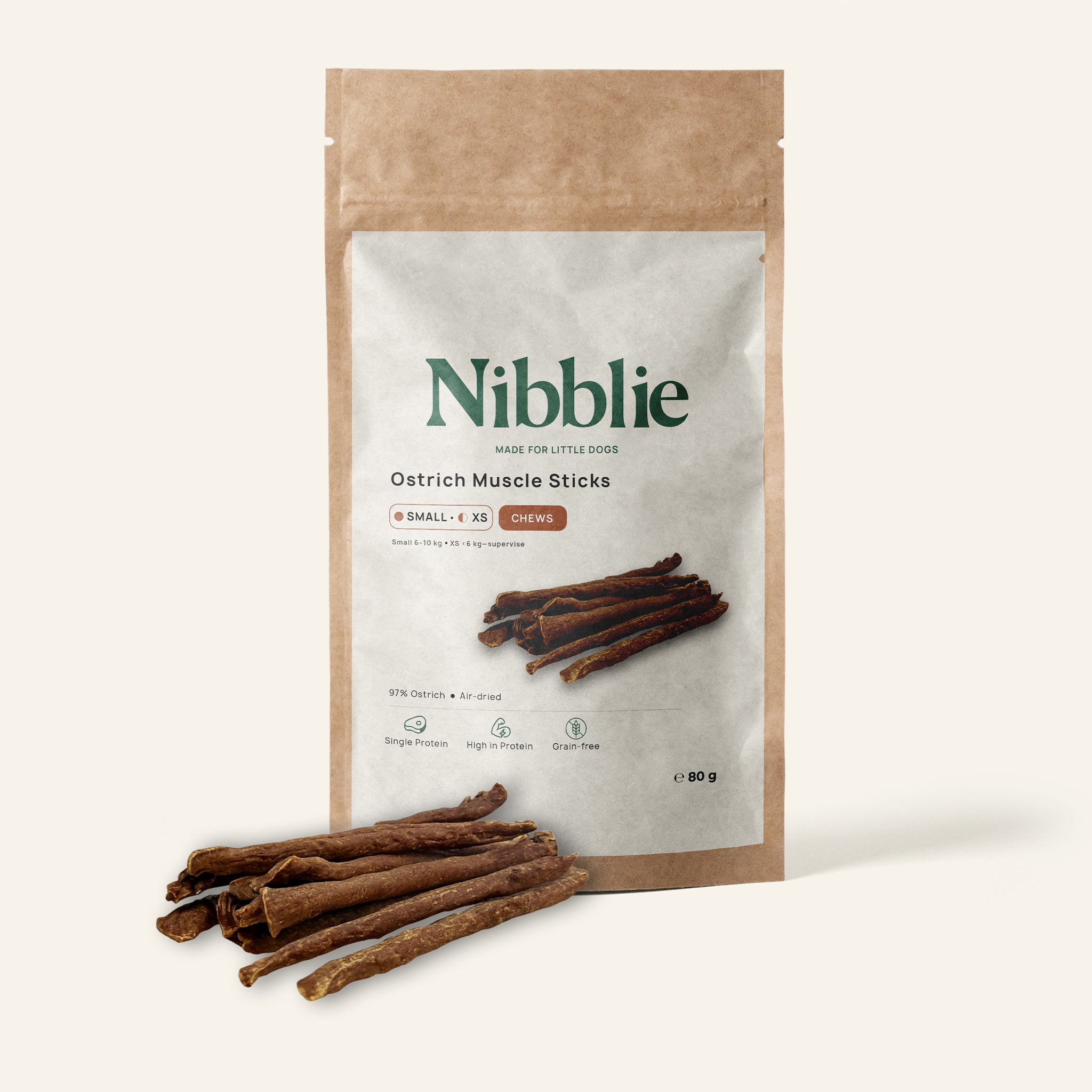 Nibblie Ostrich Muscle Sticks 80g pack on warm linen with sticks in front; light novel-protein chew for small dogs.