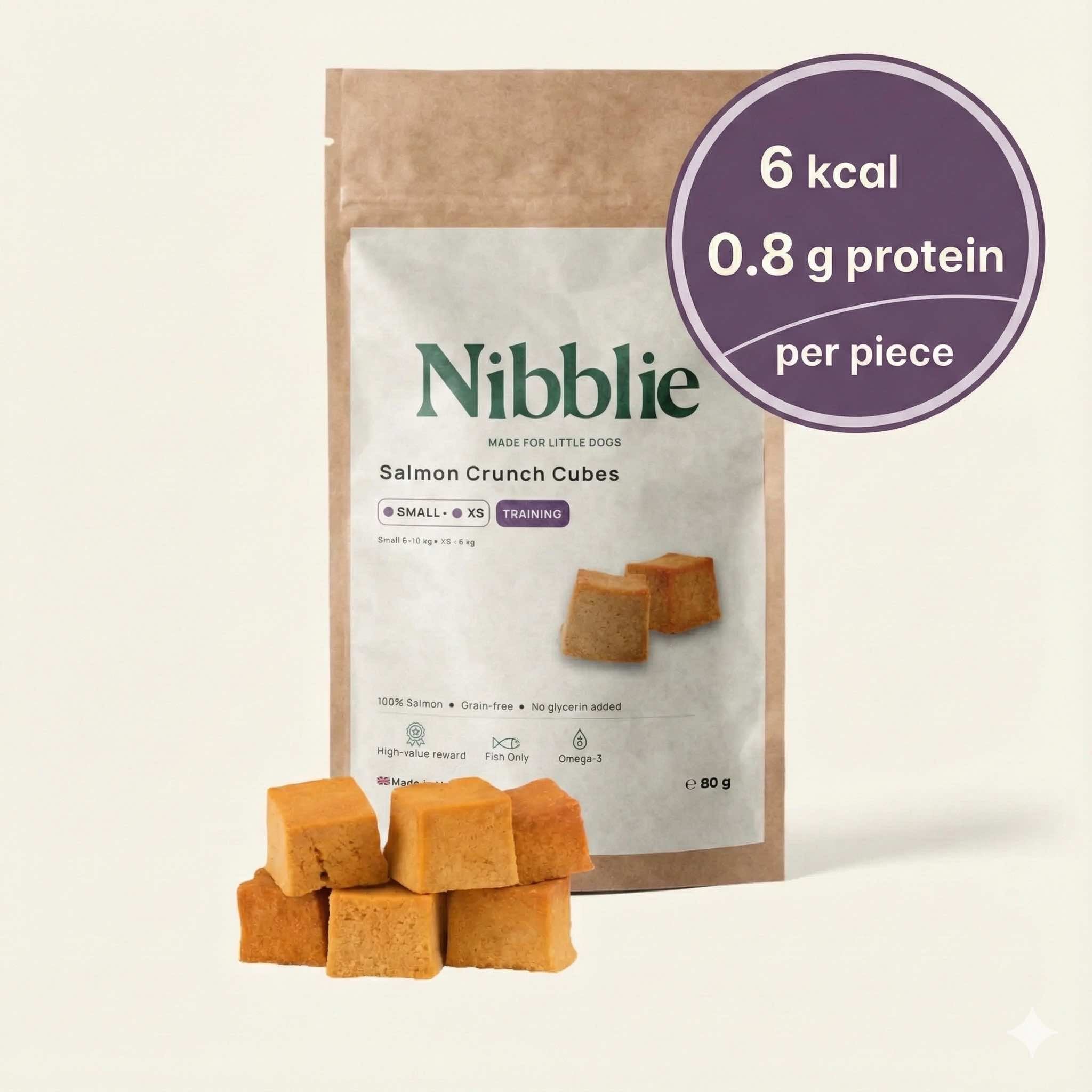 Nibblie Salmon Crunch Cubes 80g pack on warm linen with cubes in front; natural low-cal salmon treats for small dogs.