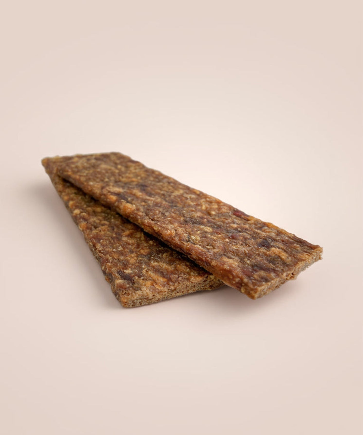 Two venison tender strip treats on a neutral background, chews category banner.
